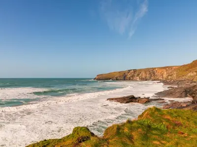 a beach with rocks and the ocean on a sunny day at Apartment Tintagel Sea view by Interhome in Treknow