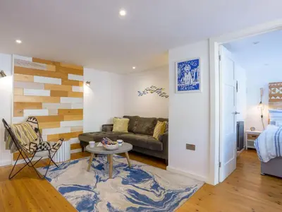 a living room with a couch and a table at Apartment Tintagel Sea view by Interhome in Treknow