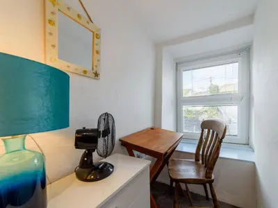a room with a desk and a chair and a window at Holiday Home Stargazey Cottage by Interhome in Mevagissey