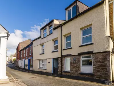 an old brick building on a city street at Holiday Home Stargazey Cottage by Interhome in Mevagissey