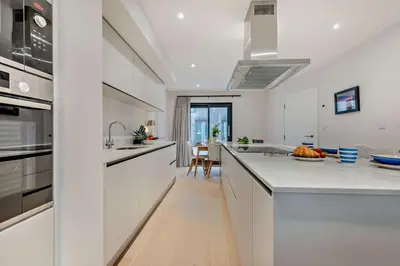 a kitchen with white cabinets and a counter top at 2 Bed in Harlyn Bay oc-s28921 in St Merryn
