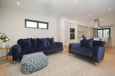 a living room with two blue couches and a table at 2 Bed in Harlyn Bay oc-s28921 in St Merryn