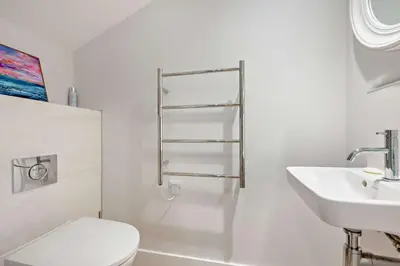 a white bathroom with a toilet and a sink at 2 Bed in Harlyn Bay oc-s28921 in St Merryn