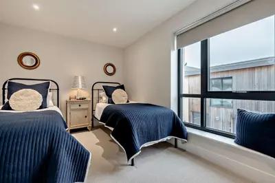 two beds in a bedroom with a large window at 2 Bed in Harlyn Bay oc-s28921 in St Merryn