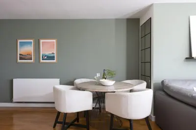 a dining room with a table and chairs and a couch at 6 The Point - Walk to Newquay's Beaches - Free WiFi and Parking in Newquay