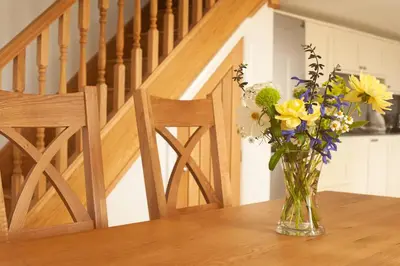a vase filled with flowers sitting on a table at Cottages at the Lugger in Portloe
