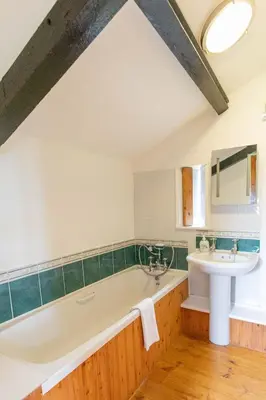 a bathroom with a tub and a sink at Treworgie Barton - Trespaddick in Bude