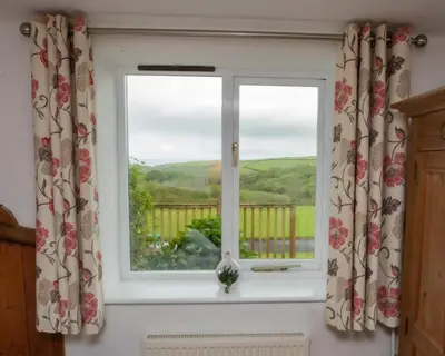a window with a view of the countryside at Treworgie Barton - Trespaddick in Bude