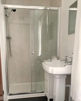 a bathroom with a shower and a sink at Jolly Sailor Inn in Looe