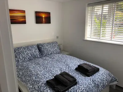 a bedroom with a bed with two towels on it at Sunnyside Retreat in St Ives