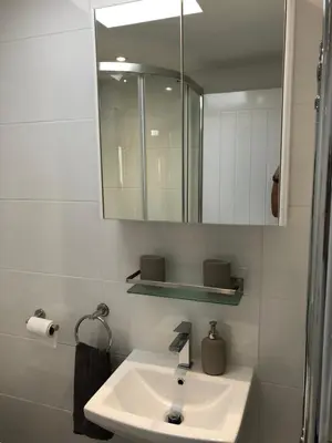 a bathroom with a sink and a mirror at Sunnyside Retreat in St Ives