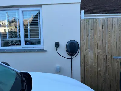 a car parked next to a house with a phone on the wall at Sunnyside Retreat in St Ives