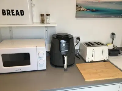 a microwave sitting on a counter next to a toaster at Sunnyside Retreat in St Ives