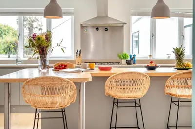 a kitchen with a counter with three bar stools at 4 Bed in St. Merryn oc-t29153 in St Merryn