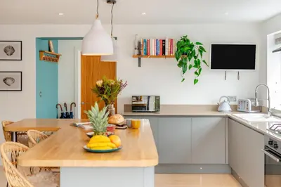 a kitchen with a wooden table with fruit on it at 4 Bed in St. Merryn oc-t29153 in St Merryn