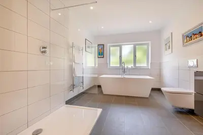 a bathroom with a tub and a toilet and a sink at 4 Bed in St. Merryn oc-t29153 in St Merryn