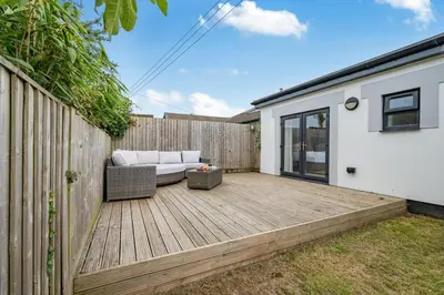 a backyard deck with a couch and a fence at 4 Bed in St. Merryn oc-t29153 in St Merryn
