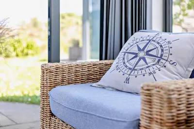 a wicker chair with a pillow with a wheel on it at 3 Bed in Trevone oc-c29020 in Padstow