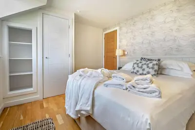 a bedroom with a bed with towels on it at 3 Bed in Trevone oc-c29020 in Padstow