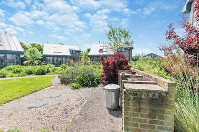 a garden with a brick wall and a trash can at 3 Bed in Trevone oc-c29020 in Padstow