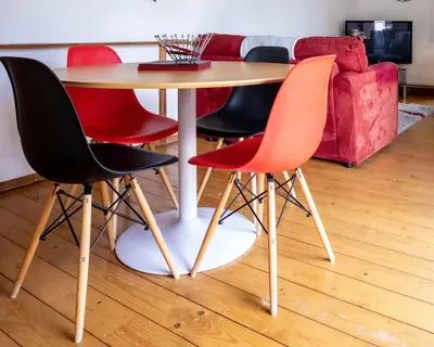 a table with four chairs around it in a living room at Treworgie Barton - Braddon in Bude