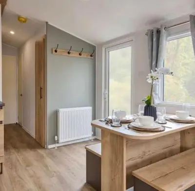 a dining room with a table and a window at Cosy Caravan New for 2024! in Newquay