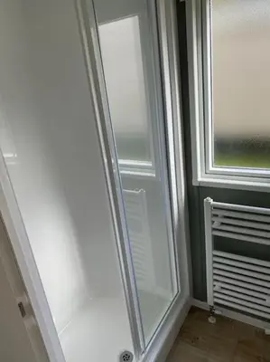 a room with a door and a window and a radiator at Cosy Caravan New for 2024! in Newquay