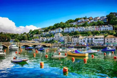 a bunch of boats in the water in a harbor at Rural Cornish farmhouse in Liskeard