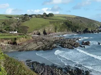 an aerial view of the ocean and a rocky coastline at Little Mainstone Guest House in Looe
