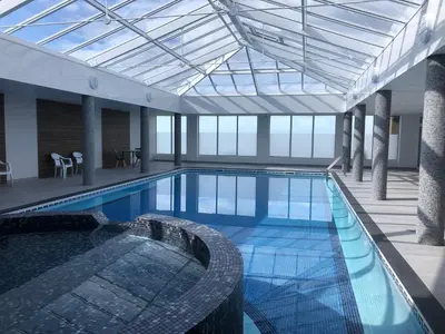 a large swimming pool in a large building at Bungalow 19 in Poundstock