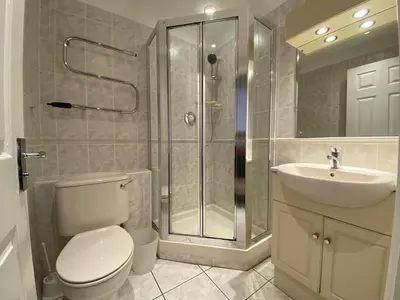 a bathroom with a shower and a toilet and a sink at 4 Bedroom House at Atlantic Reach-Newquay-Cornwall in Newquay