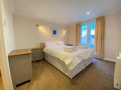 a bedroom with a bed with towels on it at 4 Bedroom House at Atlantic Reach-Newquay-Cornwall in Newquay