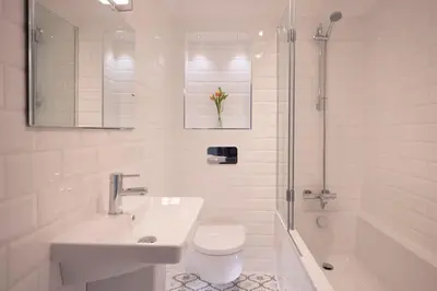 a bathroom with a sink and a toilet and a shower at Chy An Gweal Farm Cottage in Carbis Bay
