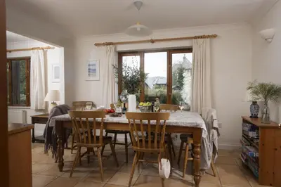 a dining room with a table and chairs at Godolphin in Wadebridge