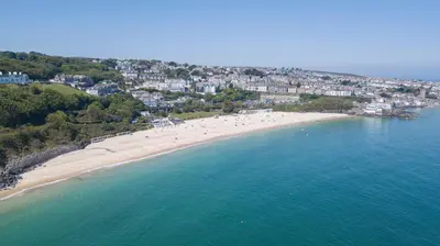 an aerial view of a beach with a group of people at Chy An Gweal Farm Coach House in Carbis Bay