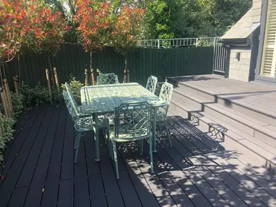 a table and chairs sitting on a deck at Chy An Gweal Farm Coach House in Carbis Bay
