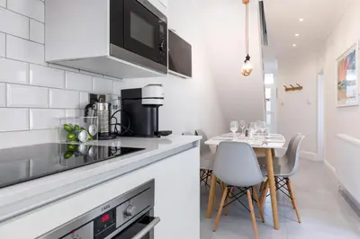 a kitchen with a table and a counter top at Beachwalk in Newquay