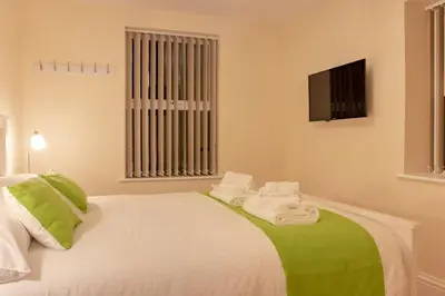 a bedroom with a bed with towels on it at Chandler's Lodge B&B in Camelford