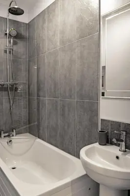 a bathroom with a white tub and a sink at Chandler's Lodge B&B in Camelford