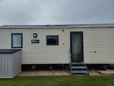 a mobile home with a door and stairs on it at 20 in Trelaske