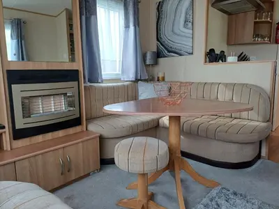 a living room with a table and a tv at 20 in Trelaske