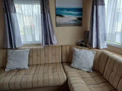 a couch sitting in a living room with windows at 20 in Trelaske
