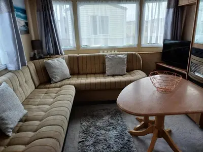 a living room with a couch and a table at 20 in Trelaske
