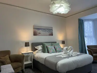 a bedroom with a bed with a swan on it at Tintagel Arms Bed and Breakfast in Tintagel