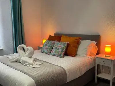 a bedroom with a bed with a stuffed animal on it at Tintagel Arms Bed and Breakfast in Tintagel