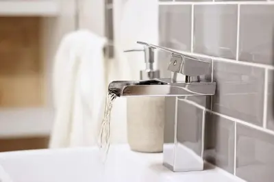 a bathroom sink with water coming out of a faucet at Scandi Cabin On A Hill, With Stunning Views Across Cornwall in Nancledra