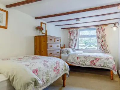 a bedroom with two beds and a window at 3 Bed in Newquay oc-82369 in Mitchell