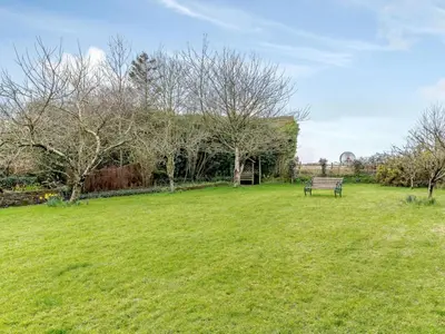 a park with a bench in a grass field at 3 Bed in Newquay oc-82369 in Mitchell