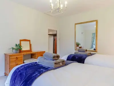 a bedroom with two beds and a mirror at 2 Bed in Newquay oc-82370 in Mitchell
