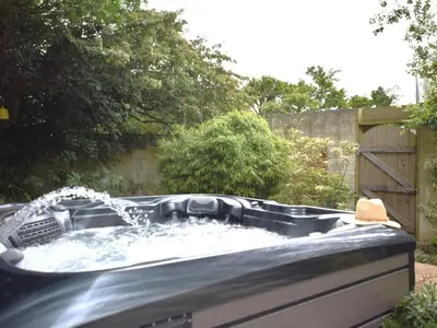 a hot tub with a fountain in a backyard at 2 Bed in Newquay oc-82370 in Mitchell